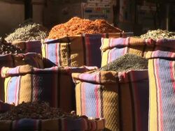 Medium, static - Pedestrians walk past bags of food products / Egypt Stock Footage