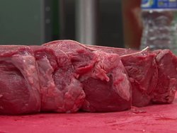 Chefs Preparing Meat in a Commercial Kitchen News Clip