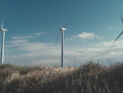 WS Girl skipping through field in front of wind turbines / Zillah, Washington, USA   Stock Footage