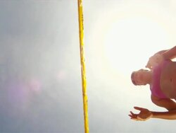 POV LA WS of female beach volleyball players spiking and blocking at the net with sun. Stock Footage