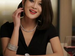 MS TU Woman looking at her diamond bracelet and smiling, sitting at dining table / China. Stock Footage