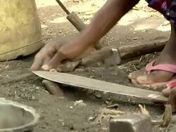 Man sharpening knife Stock Footage