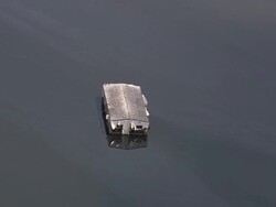 Aerial zoom out solitary house submerged in oily water / ZO flooded neighborhood / New Orleans, Louisiana Stock Footage