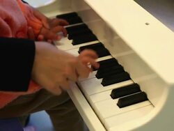 CU Shot of mother teaching daughter to play piano / Xian, China Stock Footage