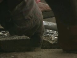 ECU Shot of man sitting on railway line sorting through electric cable and men recovering copper pipe from old heat exchangers / Lagos, Nigeria Stock Footage