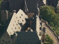 MS AERIAL Shot of Marburg castle surrounded by trees and houses / Germany Stock Footage