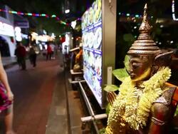 MS R/F Buddha statue in front of restaurant at night / Singapore Stock Footage