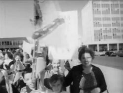 B/W 1950s children waving Confederate flags at pro-segregation rally / New Orleans, low angle / newsreel Stock Footage