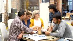 Woman talking to a group of coworkers Stock Footage