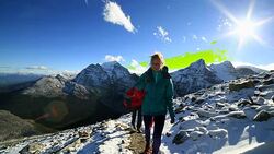 Young couple walking on mountain trail Stock Footage