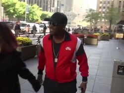 Singer, songwriter and actor Johnny Gill arrives at SiriusXM Satellite Radio and poses for photo with a fan Stock Footage