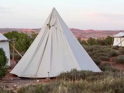 WS PAN View of canvas tents at bottom of mountains / Monument Valley, Utah, United States  Stock Footage