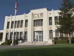 LA Taft Union High School featuring a science and education mural above the door and a flagpole / Bakersfield, California, United States Stock Footage