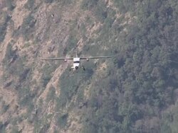 WS TS PAN ZO Prop Aircraft flying and landing on small Runway of Lukla Airport near Khumbu Valley / Lukla, Khumbu Region, Nepal Stock Footage