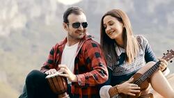 Hipster couple playing at the top of the mountain Stock Footage