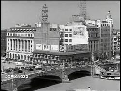 1942: PRE-WORLD WAR II MANILA: HA WS Manila city street. HA WS Vehicles on bridge. WS Building, canal FG. WS Horse-carts passing the 'Legislative Building.' WS Church cathedral. HA WS Crowded food market. MS Two boys & man at market. Philippines. Instructional Video