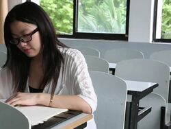 Young women playing game on a degital tablet at a cafeteria Stock Footage