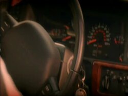 CU track forward along side of car to man starting car ignition, shot through window Stock Footage