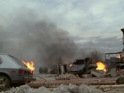 MS View of after math bombing building on fire, vehicle on its side / Los Angeles, California, USA Stock Footage