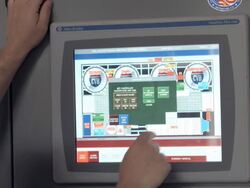 MS brew master assistant at control panel screen tapping on screen to check status of beer brewing process  / Thousand Palms, California, USA Stock Footage