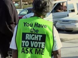 MS, ZO, Election worker wearing fluorescent vest talking to man outside polling place, Toledo, Ohio, USA Stock Footage