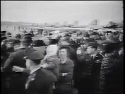 B/W 1960s high angle PAN soldiers reuniting with families outdoors / Vietnam War homecoming / California Stock Footage