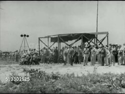 1942: FORT JACKSON REVIEW: Angled WS Covered reviewing stand w/ British Prime Minister Winston Churchill & officers seated in open (L), others standing around. WS Same area w/ VIPS dispersed, few officers & enlisted men left, car moving through frame. Instructional Video