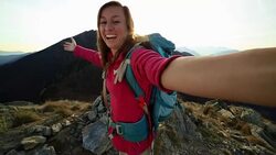 Young hiker taking selfie at mountain top Stock Footage