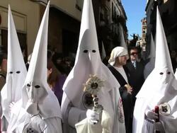 Hooded Nazarenos parade during the celebration of Semana Santa a Holy week in Malaga, Spain, Europe Stock Footage