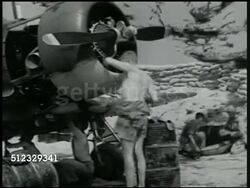 1941: U.S. MARINE BASE: REPAIRS: XLA XWS Japanese fighter airplanes flying, unconfirmed. VS Topless mechanic cleaning propellers, repairing engine of US fighter plane. REPRISAL: Mechanic & Navy Air Force pilot talking. Pacific Front, WWII Instructional Video