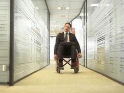 HD DOLLY: Businessman In Wheelchair Coming To Work Stock Footage