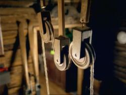CU, PAN, pulley in wooden cabin, Slovenia Stock Footage