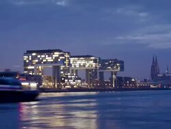 WS T/L View of skyline at dusk with modern office buildings at Rheinauhafen and Cologne Cathedral with Rhine River /Cologne, North Rhine-Westphalia, Germany  Stock Footage