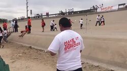 CLEAN : Mexicans in US meet relatives in the middle of border river News Clip