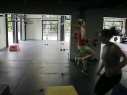 Camera tracks with Jean Anne as she performs high-knee run Stock Footage