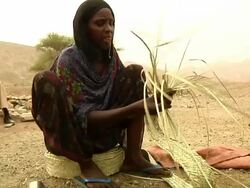 Woman braiding straw Stock Footage