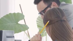 Businessman and businesswoman discussing about blueprints Stock Footage