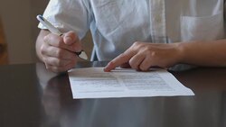 Young man filling out a document Stock Footage