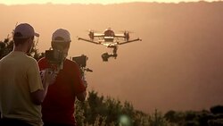 SLO MO Two UAV pilots operating drone with camera Stock Footage