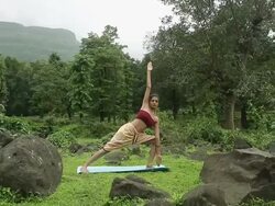 Young woman practicing yoga in the forest, Malshej Ghat, Maharashtra, India Stock Footage