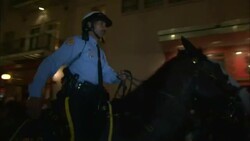 A police officer on horseback rides through a crowd on Bourbon Street. Stock Footage
