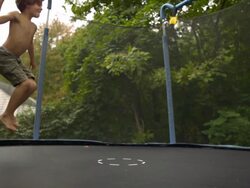 WS SLO MO shot of three Caucasian male children on trampoline, being bounced and falling / Stanford, Connecticut, United States  Stock Footage