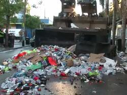 Medium Shot - Garbage truck moving trash down the street / New Orleans Louisiana Stock Footage