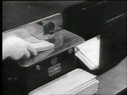 B/W 1944 close up hands of woman pushing envelopes with War Bond allotments thru machine / Chicago / news. Stock Footage