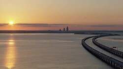 Sunset with distant view of Mobile, Alabama skyline. Stock Footage