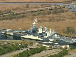 MS AERIAL Shot of USS North Carolina Battleship Museum / North Carolina, United States Stock Footage