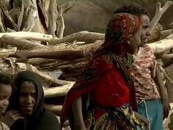 Woman and children next to wooden hut Stock Footage