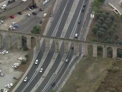AERIAL WS Highway going beneath aqueduct / Evora, Portugal Stock Footage