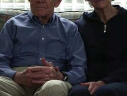 Tilting shot of a senior couple in a living room. Stock Footage