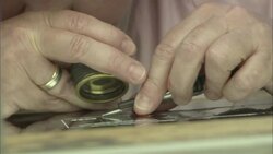 An artist etches underneath a magnifying glass. Stock Footage